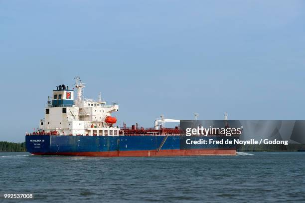 cargo ship at saigon river. vietnam. - saigon river stock pictures, royalty-free photos & images