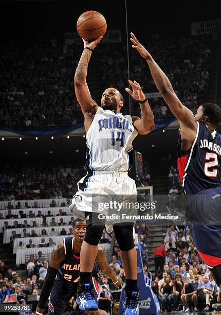 Jameer Nelson of the Orlando Magic goes up for a shot against Joe Johnson of the Atlanta Hawks in Game Two of the Eastern Conference Semifinals...