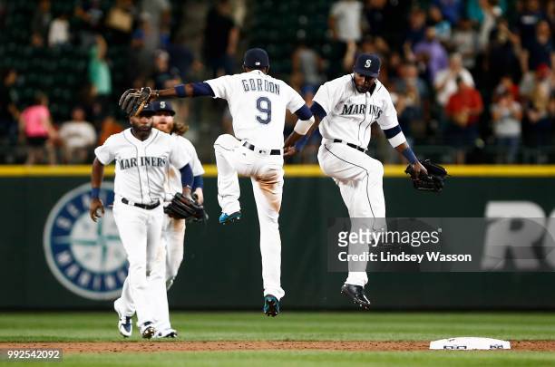 Dee Gordon of the Seattle Mariners and Guillermo Heredia celebrate their team's win against the Los Angeles Angels of Anaheim at Safeco Field on July...