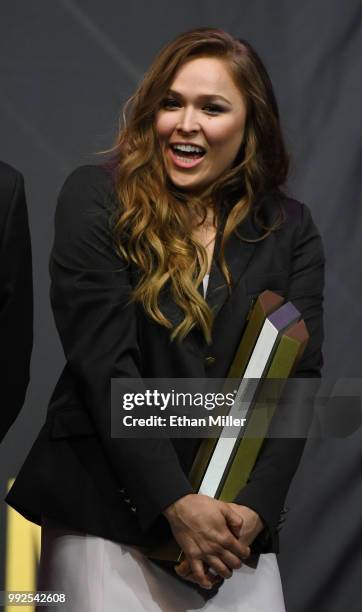 Ronda Rousey holds a trophy onstage after becoming the first female inducted into the UFC Hall of Fame at The Pearl concert theater at Palms Casino...