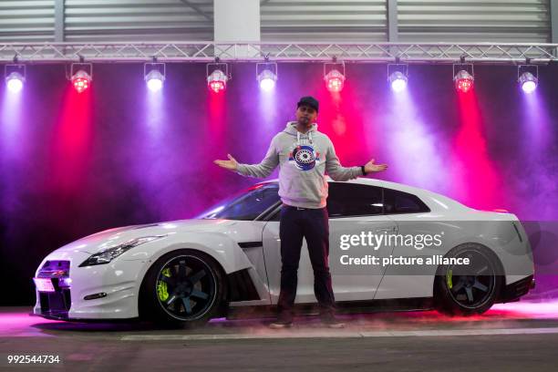 Nissan GT R35 can be seen under colorful light, presented by moderator and tuner Jean Pierre "JP" Kraemer in Essen, Germany, 23 October 2017. The...