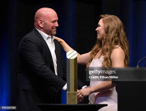 President Dana White greets Ronda Rousey onstage as she becomes the first female inducted into the UFC Hall of Fame at The Pearl concert theater at...