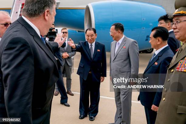 Secretary of State Mike Pompeo waves to North Korea's director of the United Front Department, Kim Yong Chol and North Korea's Foreign Minister Ri...