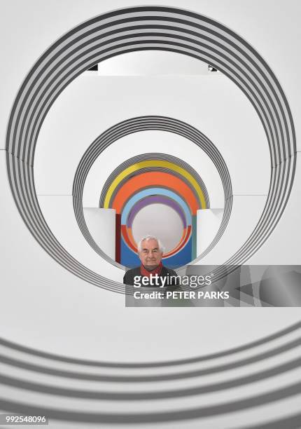 Venice Biennale Gold Lion-winning French artist Daniel Buren poses for photos in his installation "Like Child's Play" in his first Australian solo...