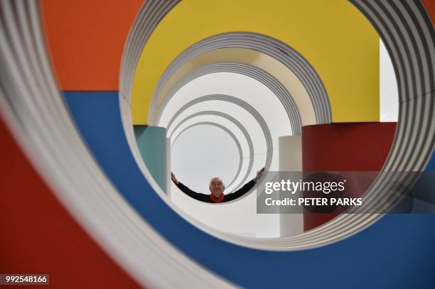 Venice Biennale Gold Lion-winning French artist Daniel Buren poses for photos in his installation "Like Child's Play" in his first Australian solo...