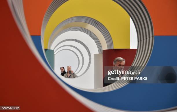 Visitors look at Venice Biennale Gold Lion-winning French artist Daniel Buren's installation "Like Child's Play" in his first Australian solo show in...