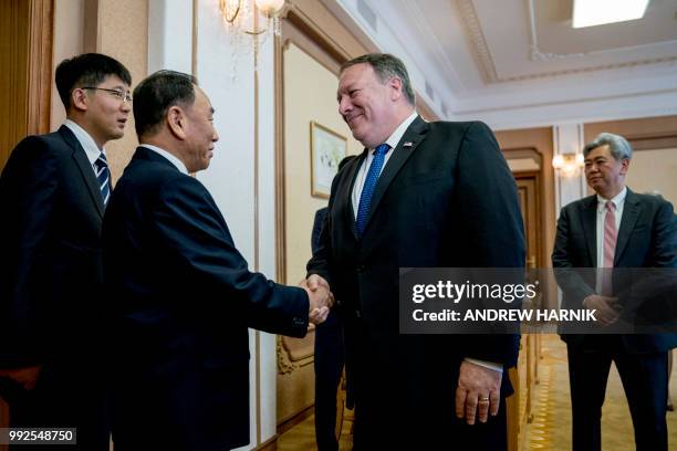 Secretary of State Mike Pompeo greets North Korea's director of the United Front Department, Kim Yong Chol as they arrive for a meeting at the Park...