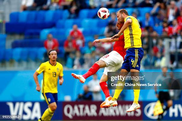 Andreas Granqvist of Sweden and Haris Seferovic of Switzerland head the ball during the 2018 FIFA World Cup Russia Round of 16 match between Sweden...