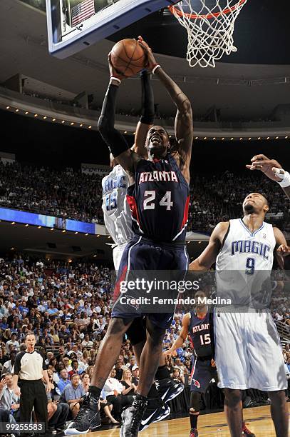 Marvin Williams of the Atlanta Hawks goes up for a shot against Vince Carter and Rashard Lewis of the Orlando Magic in Game Two of the Eastern...