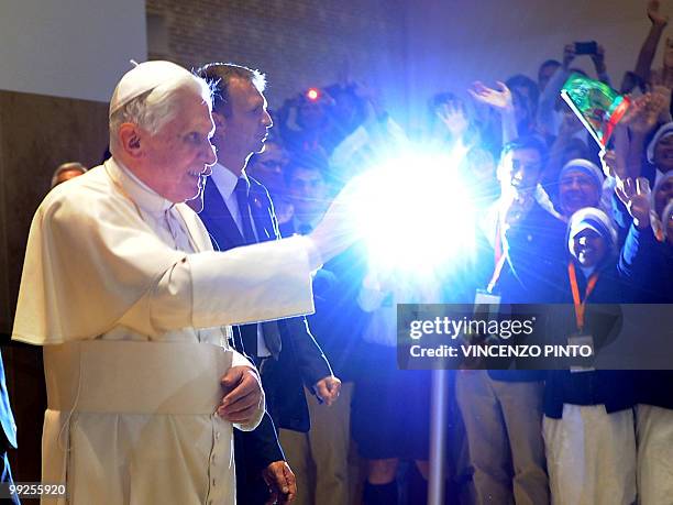Pope Benedict XVI waves as he arrives for a meeting with Church and lay social workers in Fatima on May 13, 2010. Half a million people flocked to a...