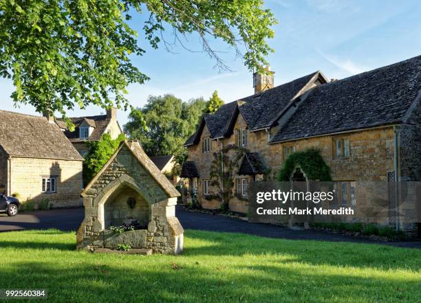 village green in lower slaughter in the cotswolds, gloucestershire, england - lower slaughter stock pictures, royalty-free photos & images