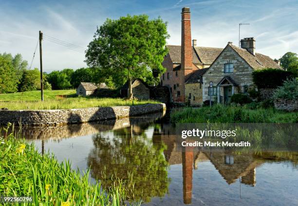 the old mill in lower slaughter in the cotswolds, gloucestershire, england - lower slaughter stock pictures, royalty-free photos & images