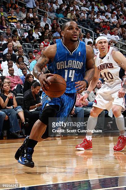 Jameer Nelson of the Orlando Magic drives to the basket past Mike Bibby of the Atlanta Hawks in Game Three of the Eastern Conference Semifinals...