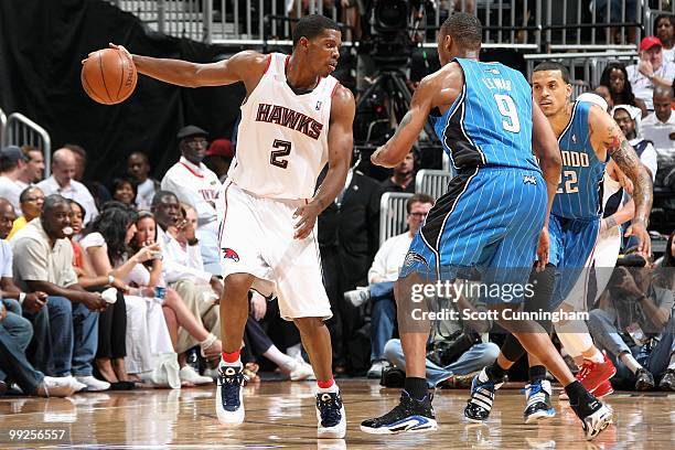 Joe Johnson of the Atlanta Hawks moves the ball away from Rashard Lewis and Matt Barnes in Game Three of the Eastern Conference Semifinals during the...