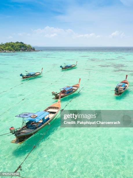 aerial view over group of long tail boats with beautiful sea and beachtop view from drone koh lipe island, satun province, thailand. - ko lipe stock pictures, royalty-free photos & images