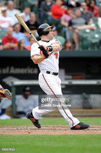 Luke Scott of the Baltimore Orioles hits a grand slam home run in the eighth inning against the Seattle Mariners at Camden Yards on May 13, 2010 in...