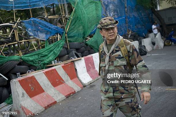 In this file picture taken on May 11, 2010 pro-red shirt Major-General Khattiya Sawasdipol inspects a barricade in the the red shirt fortified camp...