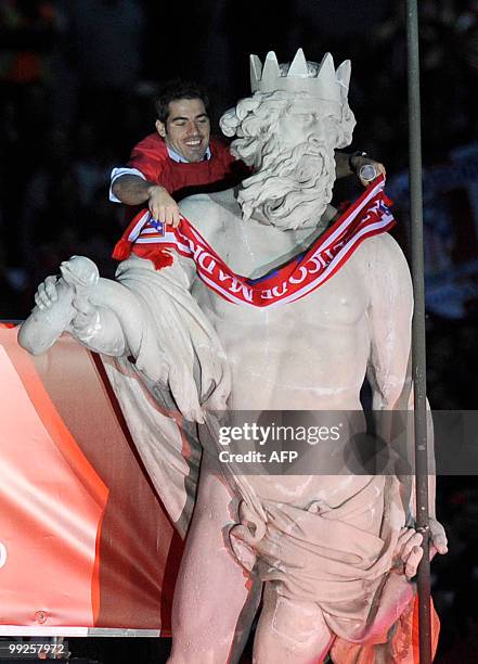 Atletico de Madrid's football supporters gather at the Neptune fountain in the center of Madrid on May 13, 2010 to celebrate with Atletico Madrid...