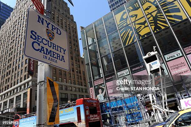 Sign warning of New York Police Department security cameras in the area is seen across Seventh Avenue from a mobile NYPD observation tower May 13,...
