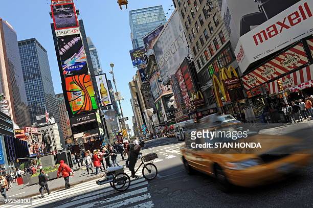 Traffic and people go through New York's Times Square on May 13, 2010. AFP PHOTO/Stan Honda