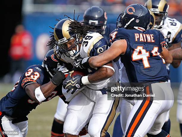 Steven Jackson of the St. Louis Rams is tackled by Kevin Payne and Charles Tillman of the Chicago Bears at Soldier Field on December 6, 2009 in...