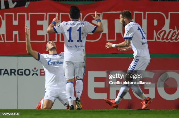 Dpatop - Schalke's Franco Di Santo celebrates with team mates Jewgeni Konopljanka and Guido Burgstaller after scoring during the German DFB Pokal...