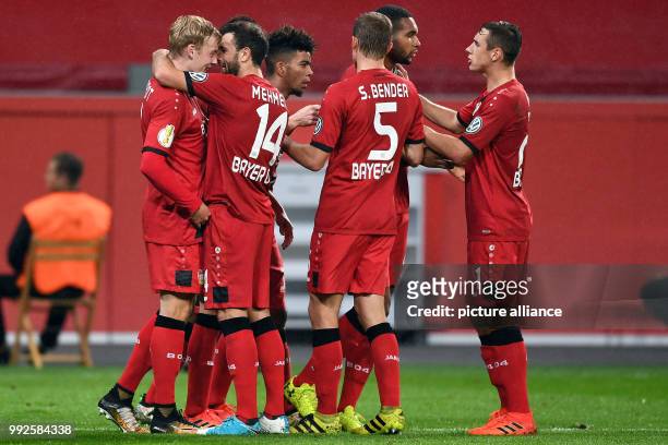 Leverkusen's Julian Brandt celebrates with team mates after scoring during the German DFB Pokal soccer cup match between Bayer Leverkusen and 1. FC...