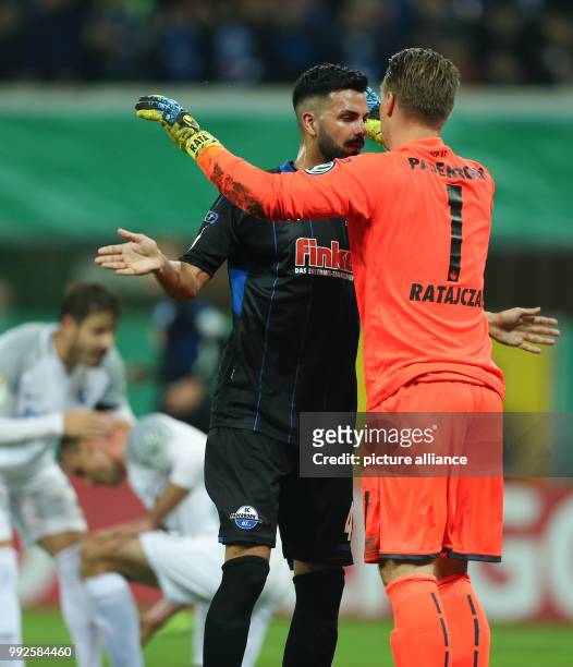 Paderborn's Massih Wassey hugging goalkeeper Michael Ratajczak , after Bochum's Felix Bastians missed a penalty shot during the DFB Cup soccer match...