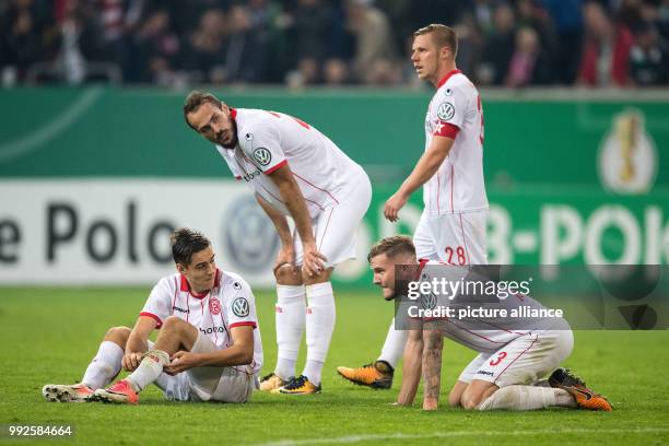 Dusseldorf's Florian Neuhaus , Emir Kujovic, Rouwen Hennings and Andre Hoffmann disappointed after their 0:1 defeat at the DFB Cup soccer match...