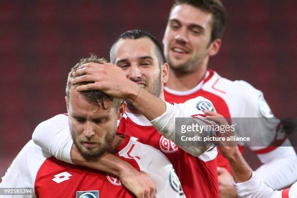 Mainz's Daniel Brosinski cheers over his 3-1 score with team mates during the DFB Cup soccer match between FSV Mainz 05 and Holstein Kiel in Mainz,...