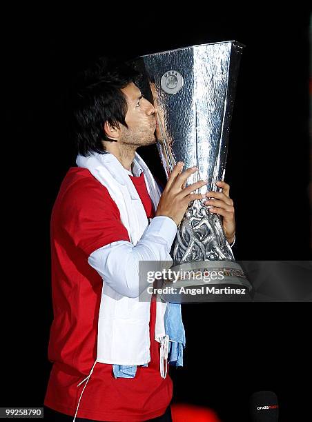 Atletico Madrid player Sergio Aguero kisses the trophy at the Neptuno fountain in Madrid the day after Atletico won the UEFA Europa League Cup final...