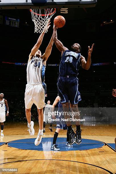 Paul Millsap of the Utah Jazz rebounds against JaVale McGee of the Washington Wizards during the game at the Verizon Center on March 27, 2010 in...