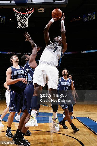 Andray Blatche of the Washington Wizards shoots against Mehmet Okur, Paul Millsap and Ronnie Price of the Utah Jazz during the game at the Verizon...