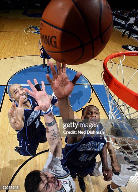 Carlos Boozer and C.J. Miles of the Utah Jazz go up for the ball against Mike Miller of the Washington Wizards during the game at the Verizon Center...