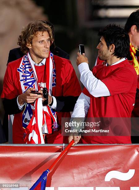 Atletico Madrid player Sergio Aguero takes a picture Diego Forlan at the Neptuno fountain in Madrid the day after Atletico won the UEFA Europa League...