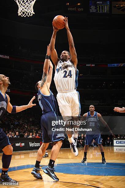 Alonzo Gee of the Washington Wizards shoots against Deron Williams of the Utah Jazz during the game at the Verizon Center on March 27, 2010 in...