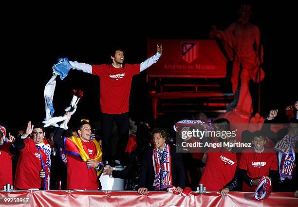Atletico Madrid player Sergio Aguero celebrates with his teammates at the Neptuno fountain in Madrid the day after Atletico won the UEFA Europa...