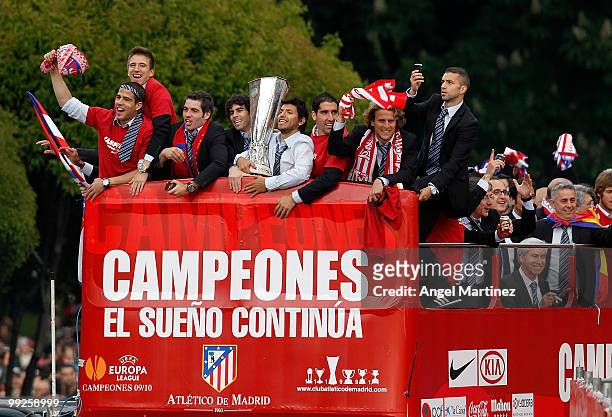 Atletico Madrid players celebrate on the top of an open bus in Madrid the day after Atletico won the UEFA Europa League Cup final on May 13, 2010 in...