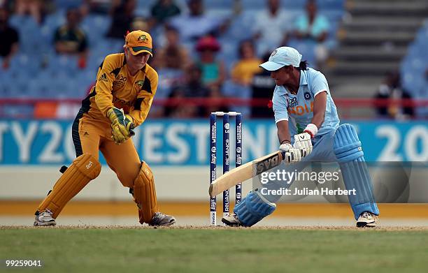 Alyssa Healy of Australia looks on as Harmanpreet Kaur of India hits out during the ICC Womens World Cup Twenty20 semi final between Australia and...