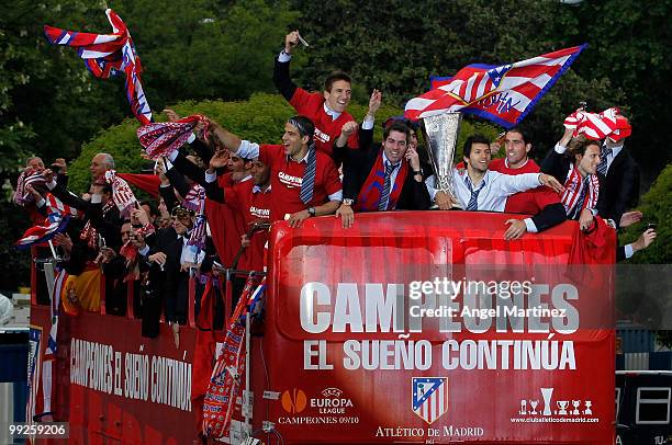 Atletico Madrid players celebrate on the top of an open bus in Madrid the day after Atletico won the UEFA Europa League Cup final on May 13, 2010 in...