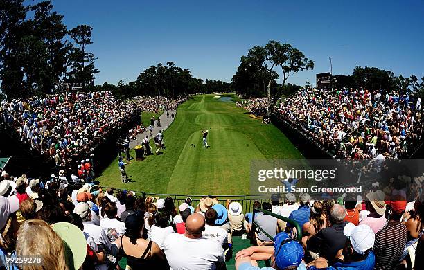 Zach Johnson plays his tee shot on the first hole as Phil Mickelson looks on during the final round of THE PLAYERS Championship held at THE PLAYERS...