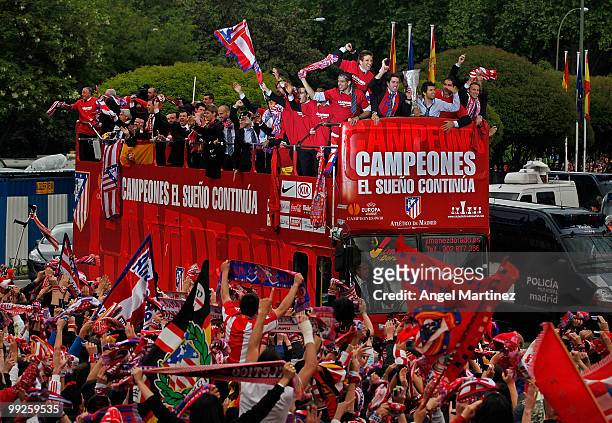 Atletico Madrid players celebrate on the top of an open bus at the Neptuno fountain in Madrid the day after Atletico won the UEFA Europa League Cup...