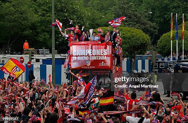 Atletico Madrid players celebrate on the top of an open bus at the Neptuno fountain in Madrid the day after Atletico won the UEFA Europa League Cup...