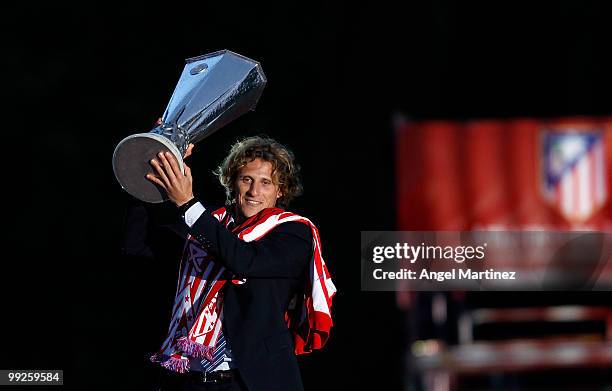 Atletico Madrid player Diego Forlan celebrates with the trophy at the Neptuno fountain in Madrid the day after Atletico won the UEFA Europa League...