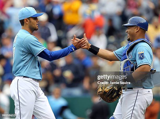 Pitcher Joakim Soria of the Kansas City Royals is congratulated by catcher Brayan Pena after the Royals defeated the Cleveland Indians 6-4 to win the...