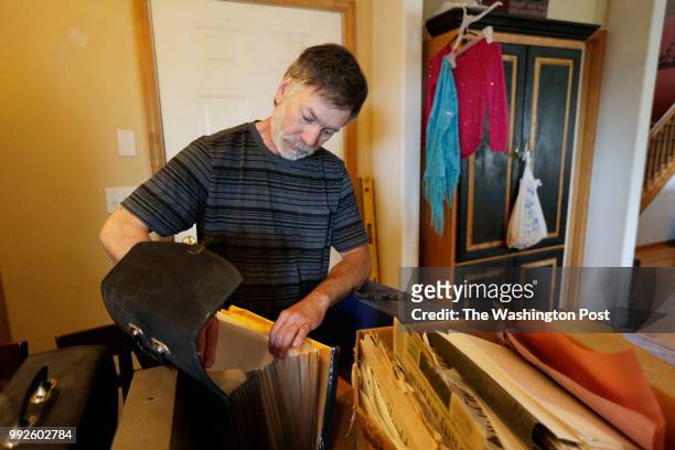Former Hanford Nuclear Reservation Nuclear Process Operator Lawrence Rouse looks through files for documents related to his illnesses at his house in...