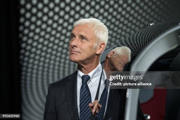 The chairman of the VW AG, Matthias Mueller, can be seen standing next to the Volskwagen concept vehicle "Sedric" after his preformance at the...