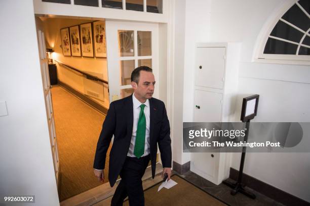 White House Chief of Staff Reince Priebus walks out before President Donald Trump speaks about the US role in the Paris climate change accord in the...