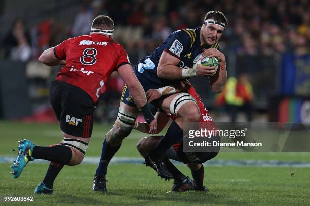 Luke Whitelock of the Highlanders is tackled by Bryn Hall of the Crusaders during the round 18 Super Rugby match between the Crusaders and the...