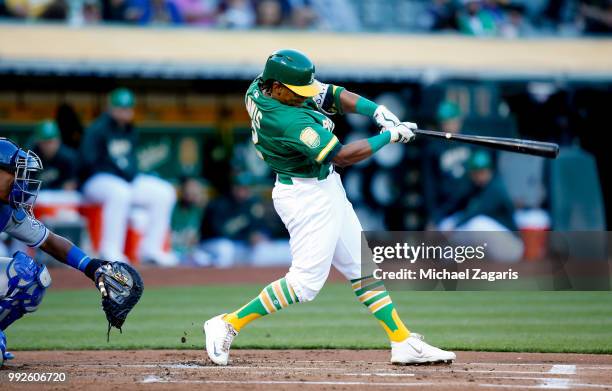 Khris Davis of the Oakland Athletics hits a home run during the game against the Kansas City Royals at the Oakland Alameda Coliseum on June 8, 2018...